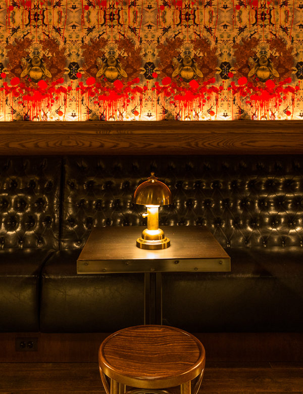Banquette seating and bumble bee wallpaper at Bounce Chicago, USA. Interiors designed by Russell Sage Studio Ltd.