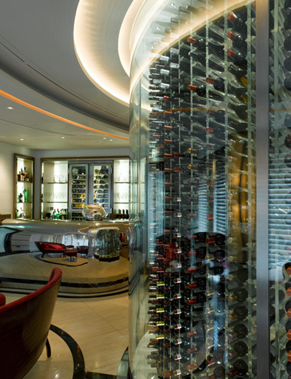 A glass wall contains hundreds of bottles of wine at Petrus, London. Interiors designed by Russell Sage Studio Ltd.